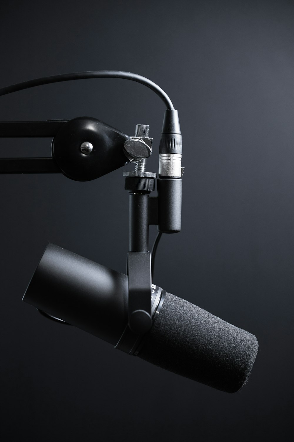 Studio microphone lit against a black background
